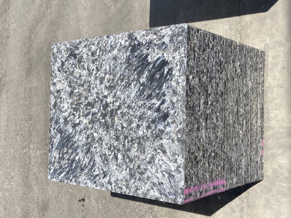 White and black GMT brick pallets showing solar heat absorption differences in outdoor brick production facility