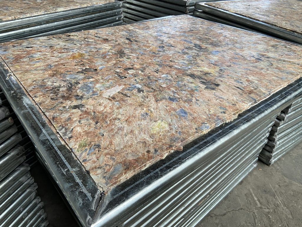 GMT brick pallet showing aluminum edge reinforcement and recycled plastic composite texture
