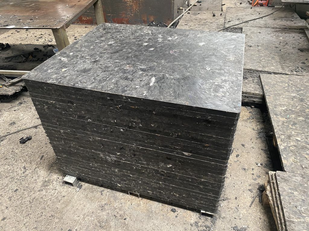 Close-up of GMT pallet material showing glass fiber mat embedded in polypropylene matrix