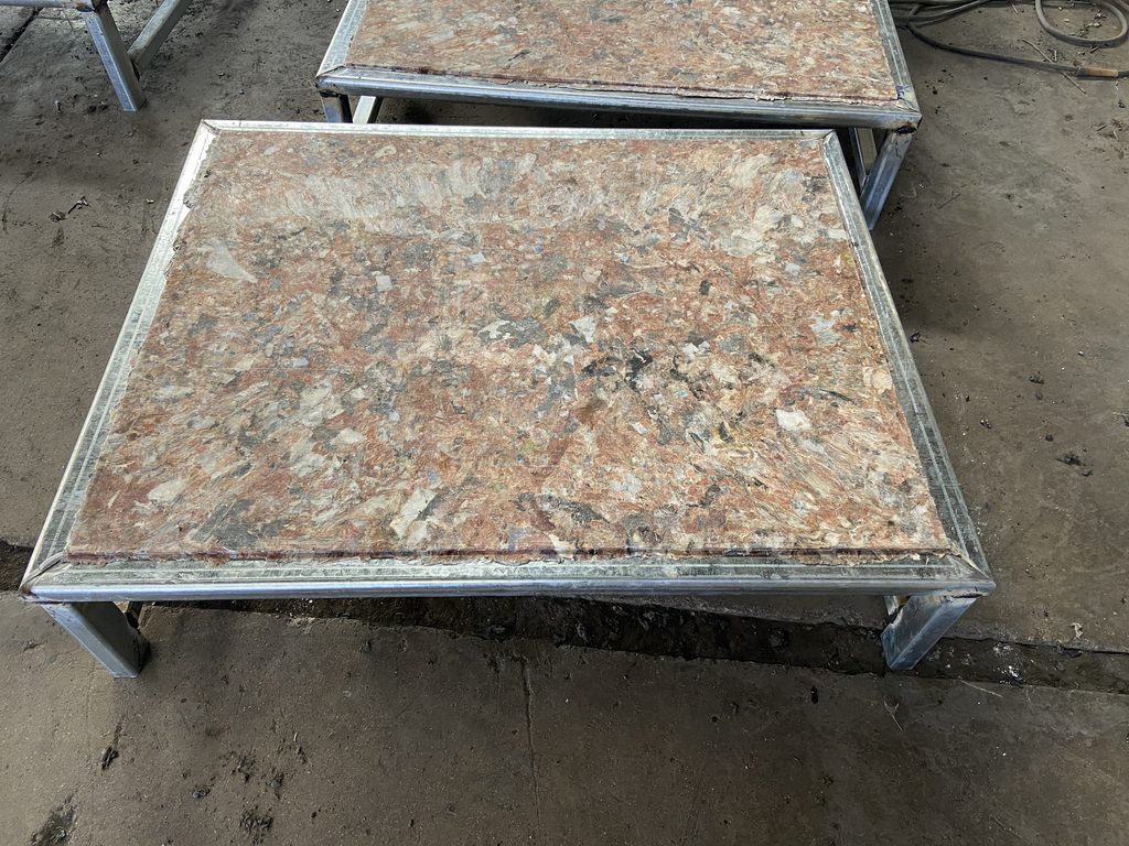 Compression molded glass fiber GMT pallets in industrial manufacturing facility