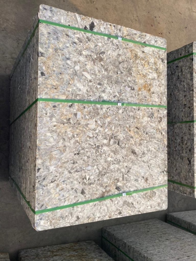 White GMT pallets with brick stacks under shade structure in tropical brick manufacturing facility