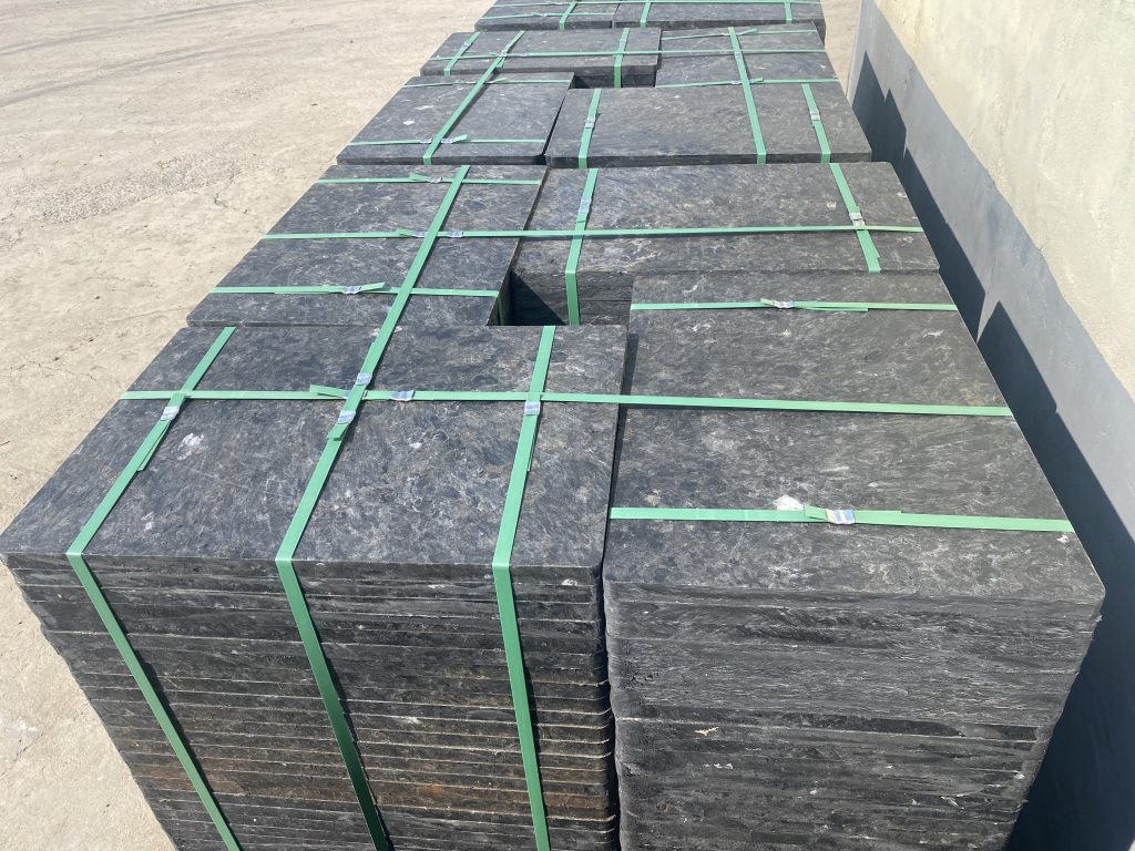 Forklift efficiently transporting stack of lightweight GMT pallets in block factory
